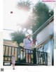 A woman standing on a balcony talking on a cell phone.