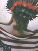 A naked woman in an indian headdress holding an American flag.