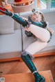 A woman sitting on top of a couch with her legs up.