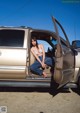 A woman sitting in the driver's seat of a car.